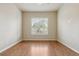 Spacious bedroom with hardwood floors and a window with shutter-style blinds for natural light at 22965 E Bailey Cir, Aurora, CO 80016