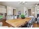 Dining area open to kitchen featuring a wooden table, upholstered chairs, and open floor plan at 22965 E Bailey Cir, Aurora, CO 80016