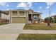 Charming two-story home featuring a covered front porch, stone accents, and well-manicured lawn at 22965 E Bailey Cir, Aurora, CO 80016