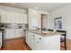 Bright kitchen featuring white cabinets, granite counters, stainless steel appliances, and a central island with bar seating at 22965 E Bailey Cir, Aurora, CO 80016