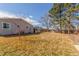 View of the backyard highlighting the expansive lawn, mature trees, and privacy fence at 3541 E 118Th Ave, Thornton, CO 80233