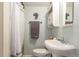 Cozy bathroom featuring a white vanity, toilet, and a shower with a stylish striped curtain at 3541 E 118Th Ave, Thornton, CO 80233