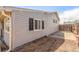 Side exterior of the home featuring neutral siding and complementary black window shutters at 3541 E 118Th Ave, Thornton, CO 80233