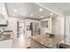 Modern kitchen with a stainless refrigerator, granite countertops, and view of the living room at 3541 E 118Th Ave, Thornton, CO 80233
