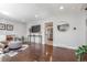 Open-concept living room with hardwood flooring, stylish seating, decor, and seamless flow to other areas at 3541 E 118Th Ave, Thornton, CO 80233