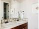 Bathroom with double sink vanity, modern fixtures, and a large mirror at 8806 E 35Th Ave, Denver, CO 80238