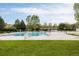 Large community swimming pool with lifeguard stands and ample seating for residents' enjoyment at 8806 E 35Th Ave, Denver, CO 80238