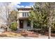 Charming two-story home with stone accents and mature landscaping creating inviting curb appeal at 8806 E 35Th Ave, Denver, CO 80238