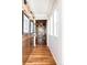 Elegant hallway featuring hardwood floors and custom built-in shelving with decorative accents at 8806 E 35Th Ave, Denver, CO 80238