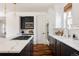 Chic kitchen featuring a large island with a gas cooktop, quartz countertops and modern fixtures at 8806 E 35Th Ave, Denver, CO 80238