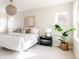 Inviting bedroom with a soft color palette, carpeted floors, and natural light from the large window at 8806 E 35Th Ave, Denver, CO 80238