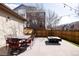 Outdoor patio with dining table, chairs, and fire pit under string lights at 8806 E 35Th Ave, Denver, CO 80238