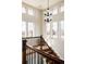 Bright staircase with large windows and modern chandelier allows natural light to flood the upstairs at 8806 E 35Th Ave, Denver, CO 80238