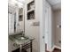 Modern bathroom with a unique glass sink, mirror, and updated fixtures at 172 S Forest St, Denver, CO 80246