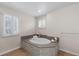 Modern bathroom with soaking tub, stylish tile, and neutral decor at 172 S Forest St, Denver, CO 80246
