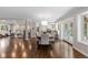 Elegant dining area with hardwood floors, a modern chandelier, and an open layout to the living room at 172 S Forest St, Denver, CO 80246