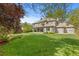 Back exterior view of home showcasing a large yard and covered patio at 172 S Forest St, Denver, CO 80246
