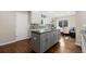 Light, bright kitchen with gray island, stainless steel appliances and light wood floors at 172 S Forest St, Denver, CO 80246