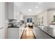 Bright kitchen with white cabinets, gray counters, stainless steel appliances, and eat in breakfast area at 172 S Forest St, Denver, CO 80246