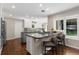 Well-lit kitchen featuring a granite island with bar seating, ample counter space, and modern finishes at 172 S Forest St, Denver, CO 80246
