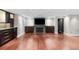 Large open living area with a fireplace, a TV, hardwood floors, and custom cabinets at 172 S Forest St, Denver, CO 80246
