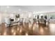 Open-concept living and dining area with hardwood floors, fireplace, and ample natural light at 172 S Forest St, Denver, CO 80246