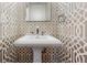Stylish powder room with unique wallpaper, modern sink and fixtures at 172 S Forest St, Denver, CO 80246