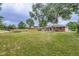 Expansive backyard with mature trees, a privacy fence, and a well-maintained lawn, ideal for outdoor activities at 8471 Rainbow Ave, Denver, CO 80229