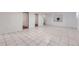 Large tiled basement area with doorways, recessed niche, and a window at 8471 Rainbow Ave, Denver, CO 80229