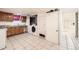 Basement laundry area with cabinets, washer/dryer, and tiled flooring at 8471 Rainbow Ave, Denver, CO 80229