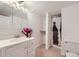 Bright bathroom with a vanity, mirror, decorative flowers, and a shower with a curtain at 8471 Rainbow Ave, Denver, CO 80229