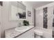 Well-lit bathroom with a marble-look shower and modern mosaic tile accents at 8471 Rainbow Ave, Denver, CO 80229