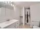 Bathroom featuring a single sink vanity, toilet, and shower with neutral tiling at 8471 Rainbow Ave, Denver, CO 80229