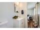 Clean white bathroom with updated fixtures and mirror over the sink at 8471 Rainbow Ave, Denver, CO 80229