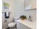 Cozy bathroom with a mirror, towel rack and picture on the wall at 8471 Rainbow Ave, Denver, CO 80229