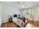 Cozy bedroom featuring hardwood floors, a large window, and neutral-toned decor at 8471 Rainbow Ave, Denver, CO 80229