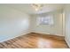 Bright bedroom features hardwood floors, neutral decor, and a large window with natural light at 8471 Rainbow Ave, Denver, CO 80229