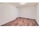 Bedroom featuring neutral walls, wood-look flooring, a closet and an overhead light fixture at 8471 Rainbow Ave, Denver, CO 80229