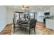 Dining area next to kitchen features wood floors, and a stylish dining set at 8471 Rainbow Ave, Denver, CO 80229