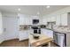 Well-lit kitchen with white cabinetry, stainless steel appliances, and granite countertops at 8471 Rainbow Ave, Denver, CO 80229