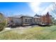 Spacious backyard featuring a well-maintained lawn, multiple decks and lush landscaping at 13633 Mariposa St, Broomfield, CO 80023