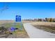 Community walking path with blue community sign at 13633 Mariposa St, Broomfield, CO 80023