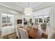 Open-concept living and dining area with hardwood floors, large windows, and a stylish decor at 13633 Mariposa St, Broomfield, CO 80023