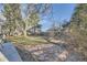 Spacious backyard with mature trees and stone walking path at 8340 W 70Th Ave, Arvada, CO 80004