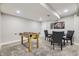 Finished basement with a foosball table, dining table, and mounted TV, creating a fun and versatile entertainment area at 8340 W 70Th Ave, Arvada, CO 80004