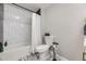 The bathroom has a tub/shower combo with stylish white subway tile and a decorative floor, offering a clean and modern look at 8340 W 70Th Ave, Arvada, CO 80004