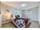 The serene bedroom features wood floors, two windows, and a bed with cozy blankets and pillows, creating a calming space at 8340 W 70Th Ave, Arvada, CO 80004