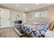 The bedroom features a bed with stylish patterned bedding and a vanity area with a round mirror, creating a cozy retreat at 8340 W 70Th Ave, Arvada, CO 80004