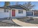 Updated ranch-style home with red front door, black trim, and low maintenance landscaping at 8340 W 70Th Ave, Arvada, CO 80004