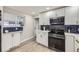 Modern kitchen with stainless appliances, subway tile backsplash, and stylish white cabinets at 8340 W 70Th Ave, Arvada, CO 80004